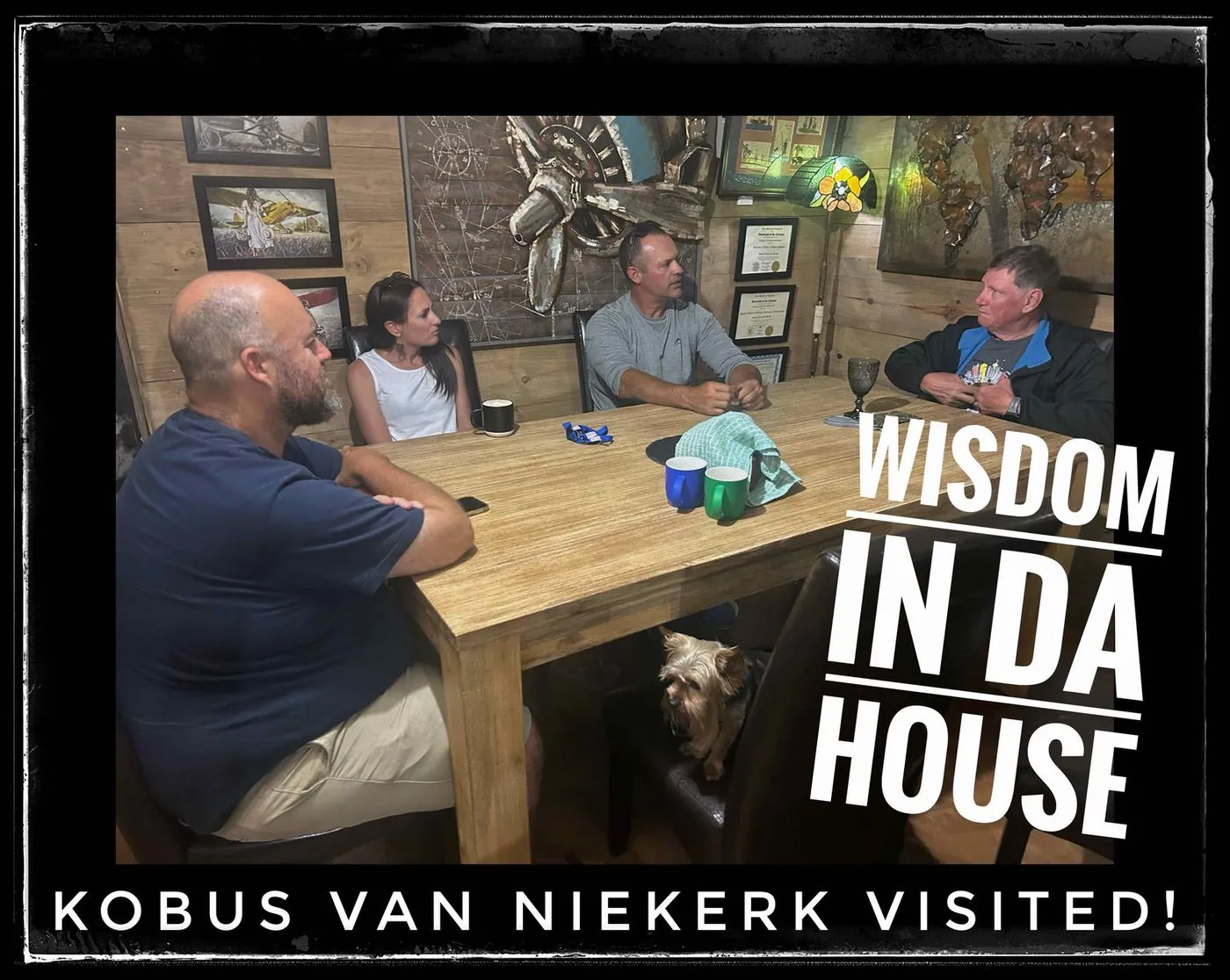 Five men sitting around a wooden table in a rustic room, captioned Wisdom in da house, Kobus van Niekerk visited!